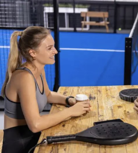 Player chatting over a coffee courtside after padel